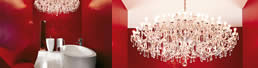 Striking Interior design of scarlet red bathroom with white plank flooring, Laufen sanitary wares & Panton Heart chair.